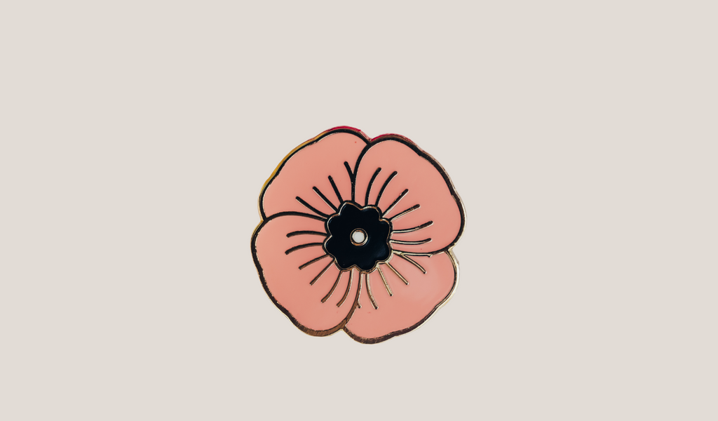 photo of a single peach poppy enamel pin on an of white background