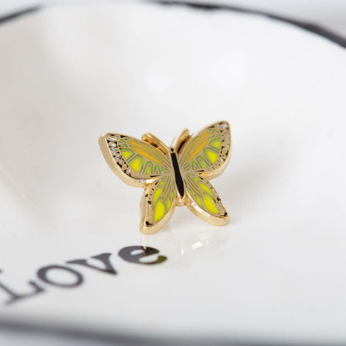 Butterfly-shaped object on a white surface with 'LOVE' text