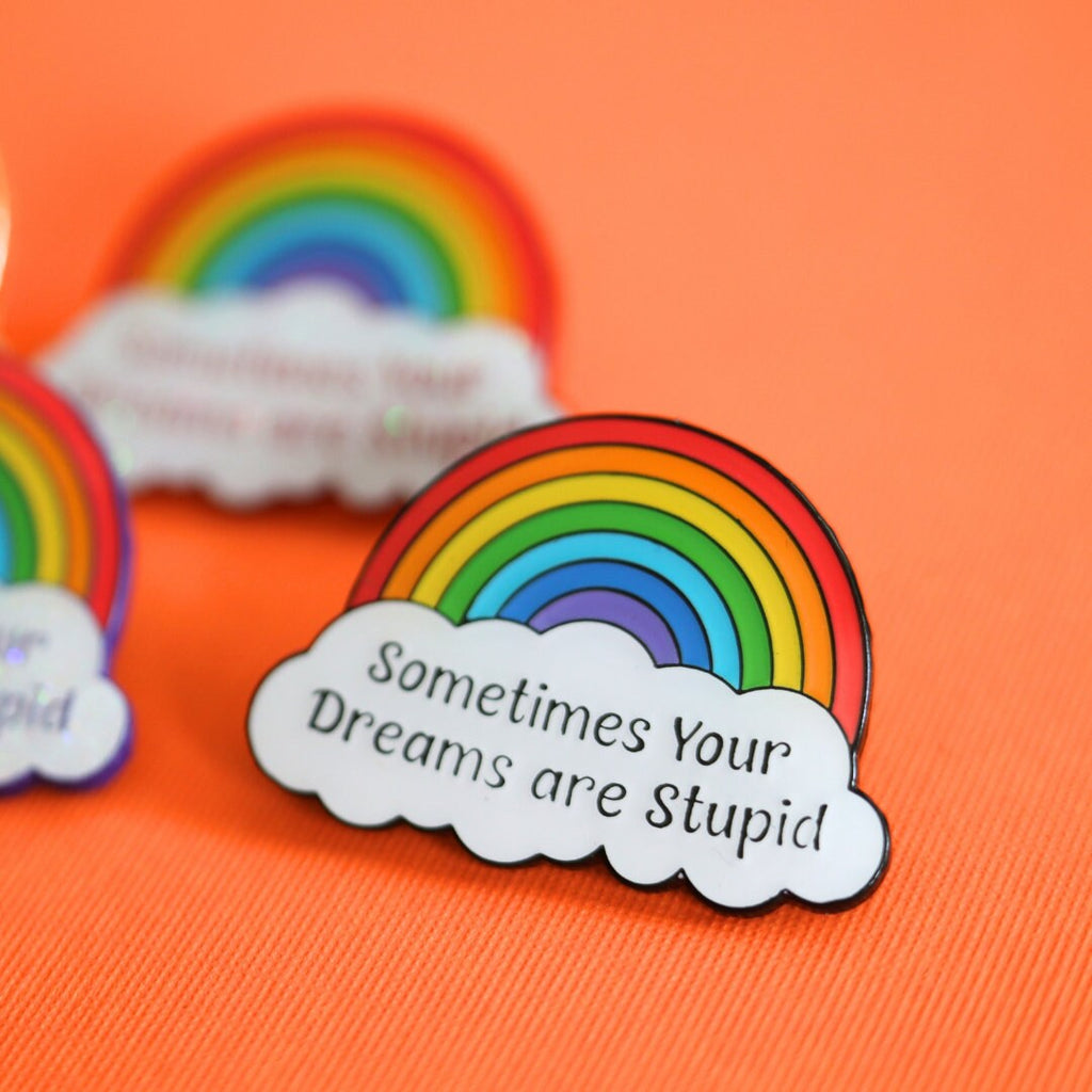 a rainbow pin sitting on top of a table